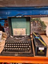 A vintage Imperial typewriter, cased and entitled the Good Companion and a boxed 'Chocogil' champagn