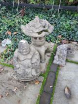 Three garden figures, one being a small buddha