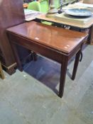 An antique mahogany foldover tea table on square moulded legs and one other card table having centra