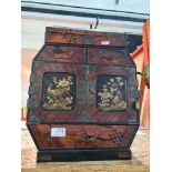 Miniature oriental chest having numerous drawers, the doors decorated birds and flowers