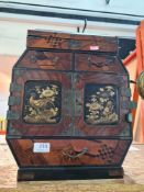 Miniature oriental chest having numerous drawers, the doors decorated birds and flowers