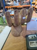 A carved wooden seat in form of hand
