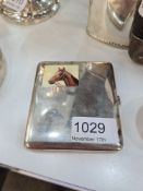 A pretty silver cigarette case having clear image of a horse on the top left had side. Gilt interior