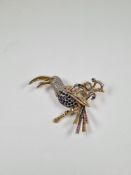 An 18ct white and yellow gold beautiful brooch of a Toucan sitting on branch with floral spray inset