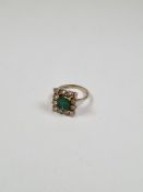 18ct white gold dress ring with central cushion cut emerald, approx 7mm, surrounded 12 round brillia