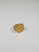 A 9ct yellow gold ring of decorative floral design mounting a 22ct gold full Sovereign dated 1911, G