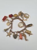 9ct yellow gold charm bracelet hung with 13 charms to include articulated sea horse and turtle, Zodi