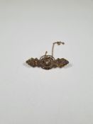 Victorian 15ct gold brooch of decorative form and central diamond, safety chain, marked 15ct, approx