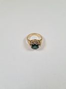 14K yellow gold dress ring with central round cut tourmaline surrounded white sapphires, marked 585,