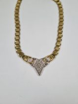 18ct yellow gold neckchain, with central V shaped panel inset with 8 small round brilliant cut diamo