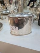 A Victorian silver tea caddy of oval form, having repoussed bordered details. Hallmarked Birmingham