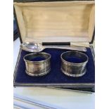 A cased pair of silver napkin rings by G E Walton and Co Ltd. Having beaded borders. Birmingham 1918