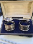 A cased pair of silver napkin rings by G E Walton and Co Ltd. Having beaded borders. Birmingham 1918