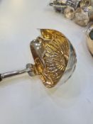 A silver ladle having decorative bowl, silver gilt interior and half reeded design, possible maker's