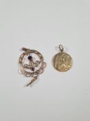 9ct yellow gold St Christopher, marked 375, and a yellow metal circular pendant inset with half pear