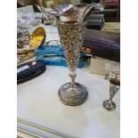 Decorative white metal items to include a heavily embossed trumpet vase, the body decorated with flo