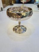 An art Nouveau silver dish standing on a domed circular foot. The tall stem having embossed details,