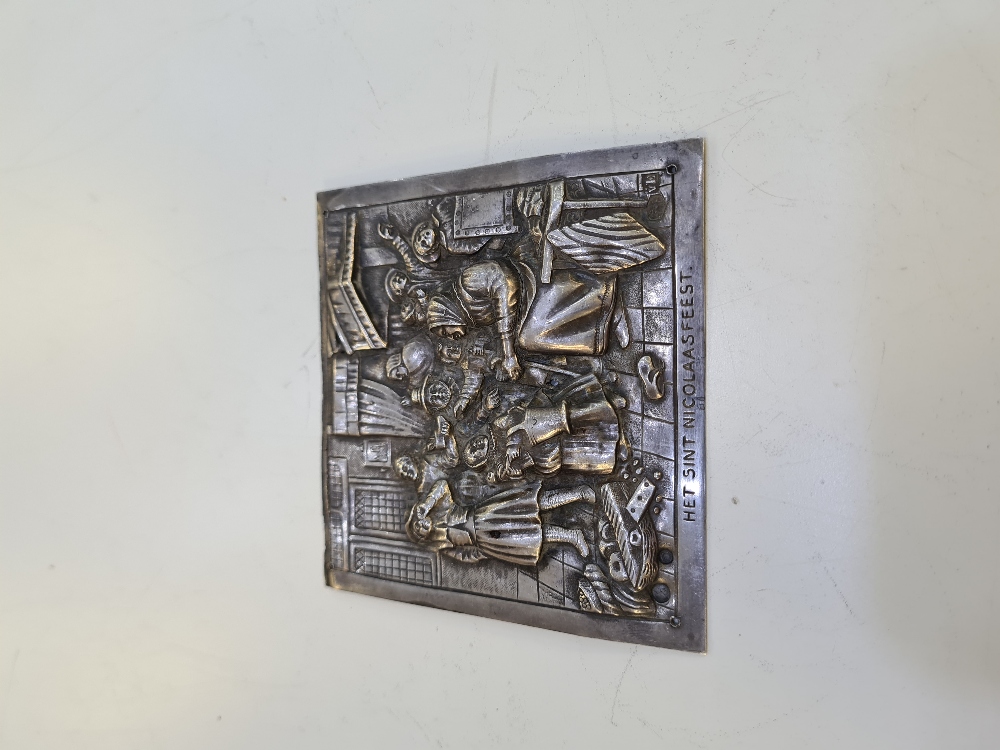 A silver Dutch plaque depicting Het Sint Nicolaas Feest in embossed design in relief, Decorative des