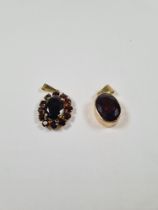 Two 8ct yellow gold garnet set pendants, marked 333, one oval faceted garnet and the other a cluster