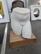 An old marble sculpture of female lower torso on later square base, the sculpture 47cm