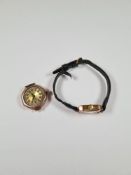 9ct yellow gold cased watch head, no glass, marked 375, and a 9ct gold cased watch on black leather