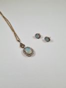 Antique 9ct yellow gold ropetwist necklace hung with an oval pendant with large opal surrounded by r