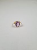 Unmarked 18ct yellow gold dress ring set with large oval faceted amethyst in claw mount, size M, app