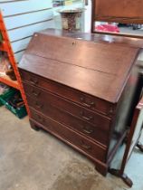 An antique oak bureau having four long graduated drawers, late 18th Century