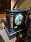 A Victorian black marble mantle clock