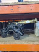 A small brass model Cannon on cast iron base
