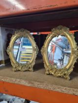 A pair of reproduction gilt oval easel mirrors