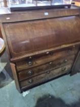 An antique mahogany cylinder bureau having 3 long drawers and an oak Student's bureau