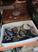 An antique jewellery box and small tray of costume jewellery