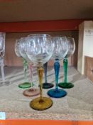 A set of 6 engraved Champagne flutes having air twist stems and 6 other wine glasses