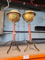 A pair of reproduction miniature globes on tripod supports