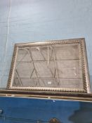 A reproduction mirror having silvered frame with bevelled glass