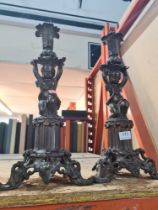 A pair of bronze style spelter candlesticks decorated cherubs 43.5cm