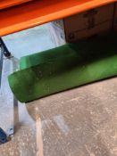 A large roll of green felt