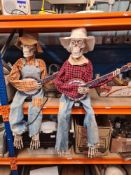 A pair of electrically operated musical skeletons dressed as cowboys with moving parts