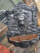 An old cast iron water fountain decorated Lion Mask and Angels