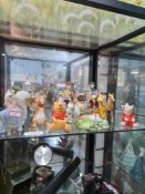 A quantity of Beswick Beatrix Potter figures, Winnie the Pooh figures, a Doulton snowman and similar