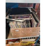 A shelf of vinyl LP's mixed genres and a box of 7" singles