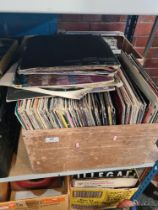 A shelf of vinyl LP's mixed genres and a box of 7" singles