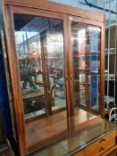 A vintage Nathan display cabinet having mirror back with drawers and cupboards below