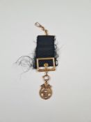 9ct yellow gold Masonic medal with 9ct gold bar black ribbon square buckle hung with 9ct gold Masoni