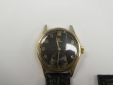 Omega; an unusual 9ct gold cased Omega watch with black dial, gold outlined arabic hour markers, out