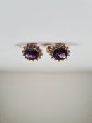 Pair of 14ct yellow gold amethyst and diamond cluster earrings, each with central large oval cut ame