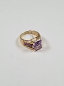 9ct gold dress ring set with raised large step cut amethyst and the band set with chanel set amethys