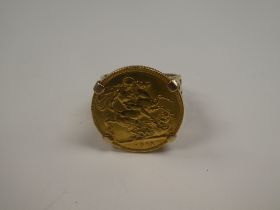 A 9ct yellow gold ring of decorative floral design mounting a 22ct gold full Sovereign dated 1911, G