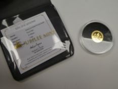 The Jubilee Mint; A 9ct gold commemorative coin, 1g 'The Queen Elizabeth II Birthday' with Certifica